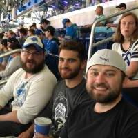 group of three men smiling at the football game